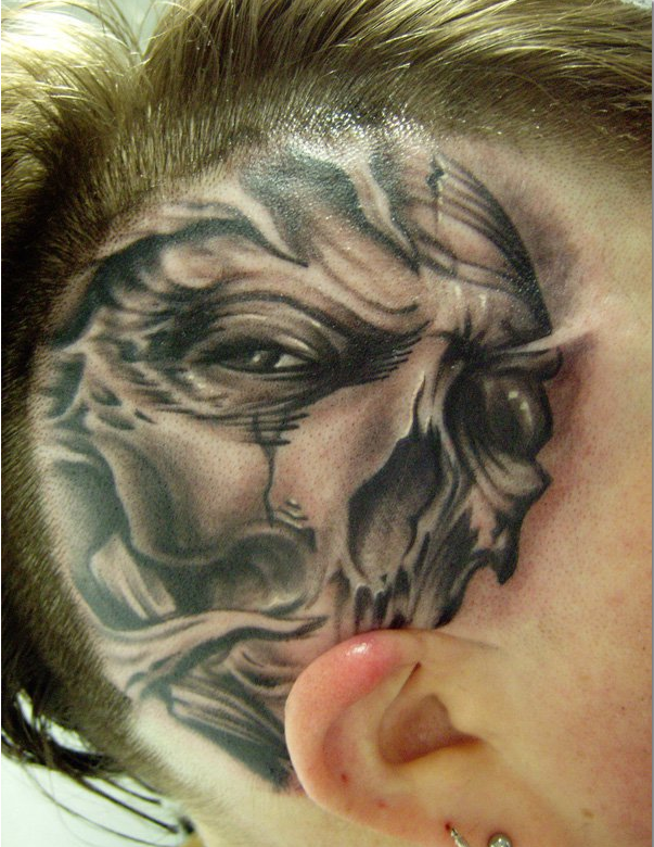 Freehand skull on head tattoo