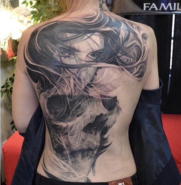 Girl and skull tattoo on back for woman