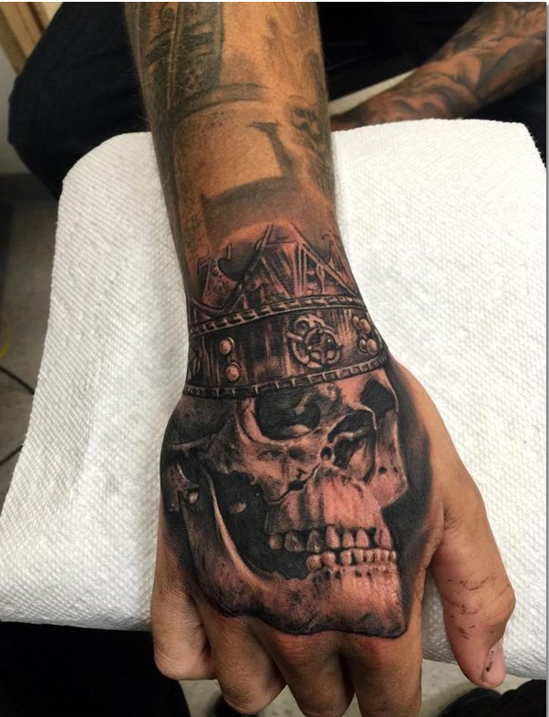 Skull tattoo on hand for men